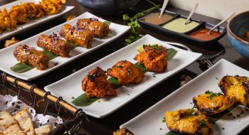 A dinner table with fried meat dishes and sauces
